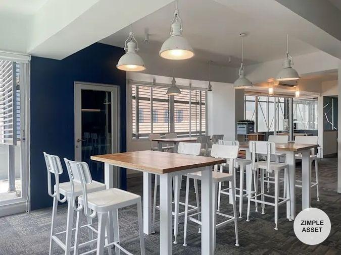 picture Office for rent with modern coworking space, Blue Chips Thonglor Building. Inside is a modern lobby that opens up to a contemporary office space. - 4/9