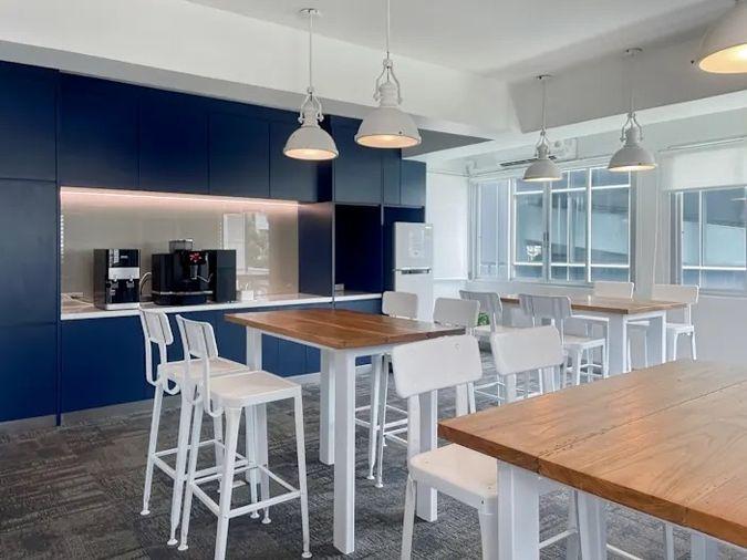 picture Office for rent with modern coworking space, Blue Chips Thonglor Building. Inside is a modern lobby that opens up to a contemporary office space. - 3/9