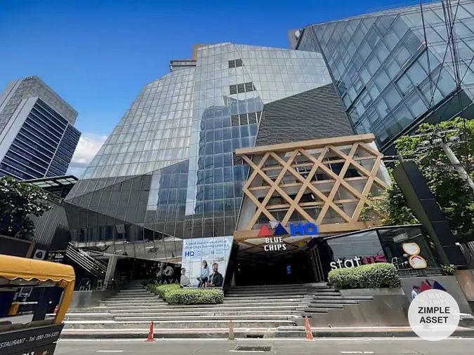 picture Office for rent with modern coworking space, Blue Chips Thonglor Building. Inside is a modern lobby that opens up to a contemporary office space. - 1/9