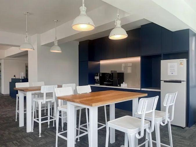 picture Office for rent with modern coworking space, Blue Chips Thonglor Building. Inside is a modern lobby that opens up to a contemporary office space. - 5/9