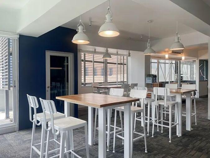picture Office for rent with modern coworking space, Blue Chips Thonglor Building. Inside is a modern lobby that opens up to a contemporary office space. - 1/9